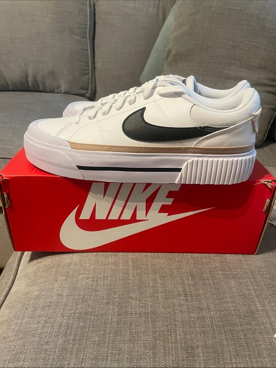 Nike Shoes - Nike womens White Low-Top Sneakers with Black Swoosh and Tan Accent